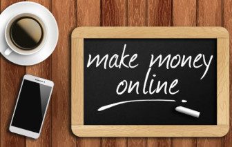 coffee, phone and chalkboard with make money online words.